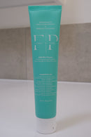 Front of a 100g Flossy & Pure Mild Mint nano-hydroxyapatite toothpaste tube on a bathroom bench