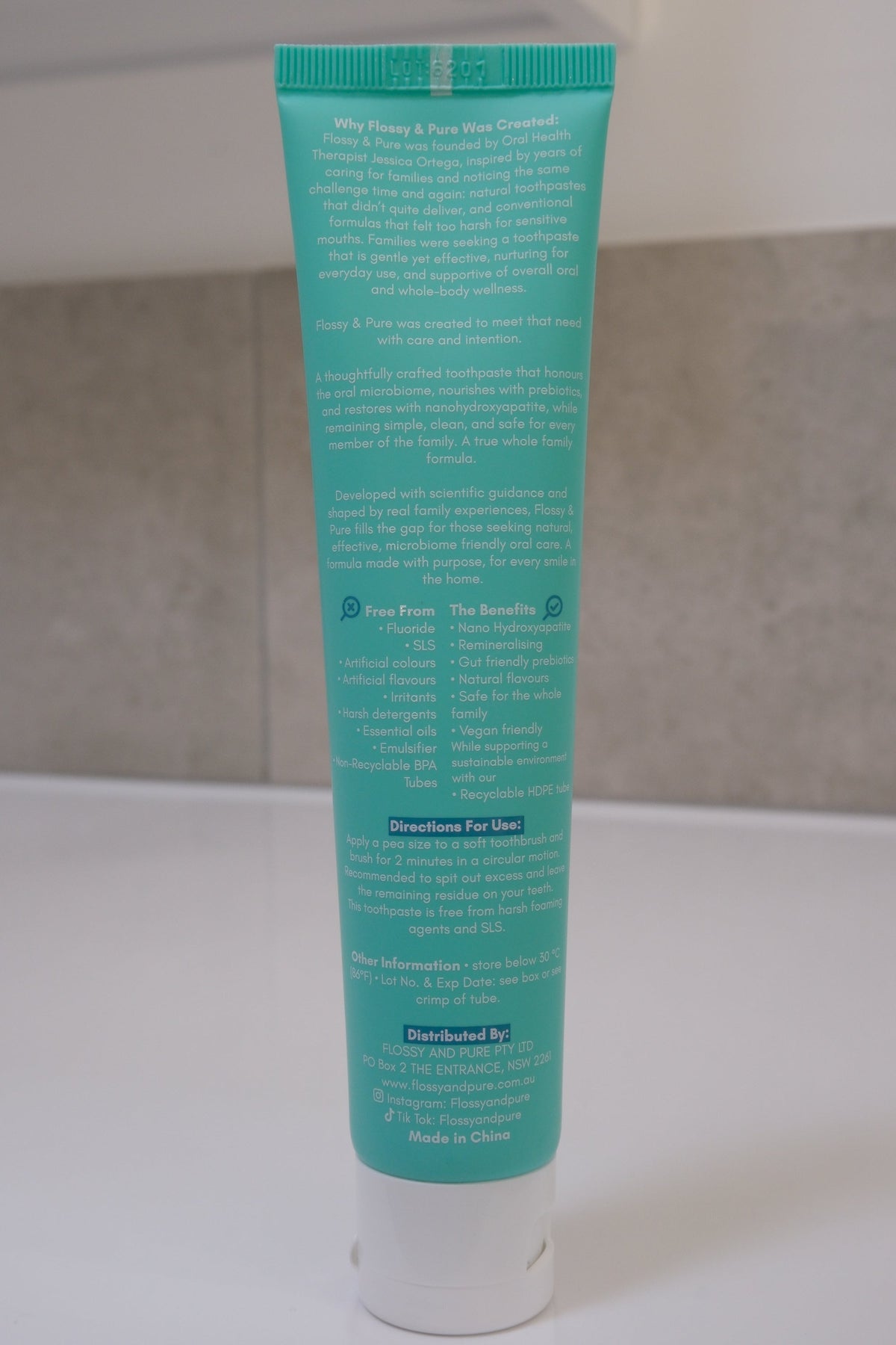 Back of a Flossy & Pure Mild Mint toothpaste tube showing the directions for use