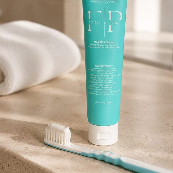 Low-foam paste on a toothbrush